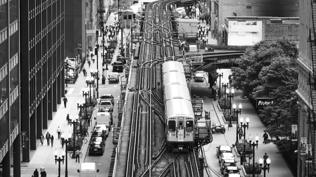 Image of Train on track in black and white in big, inner city aerial of Chicago tourism transit and travel