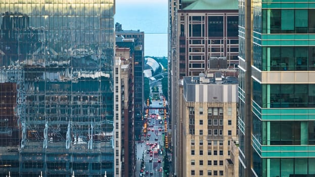 Image of Chicago street cutting through skyscraper buildings with architecture in city aerial, tourism