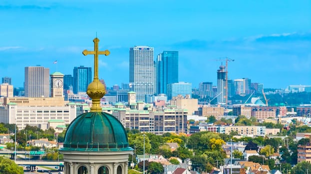 Sweeping aerial view of Milwaukee's vibrant skyline showcasing the historic Basilica of St. Josaphat, bustling downtown area and residential districts, captured via DJI Mavic 3 drone.