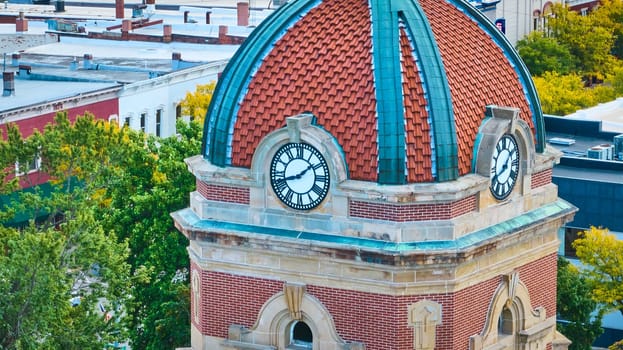 Historic Elkhart County Courthouse clock tower with vibrant dome in downtown Goshen, Indiana, captured from an aerial perspective