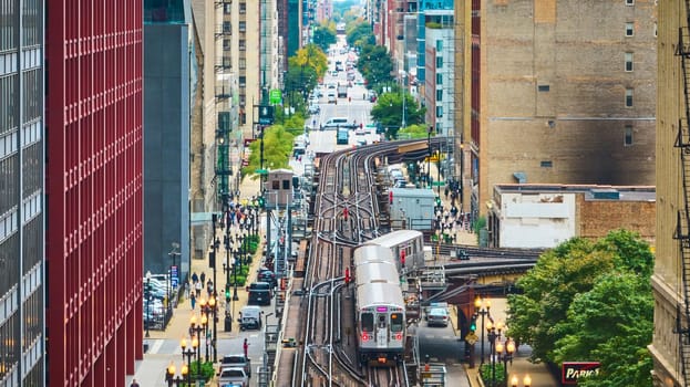Image of Train on railroad in big, inner city aerial of Chicago tourism transit and travel on summer day