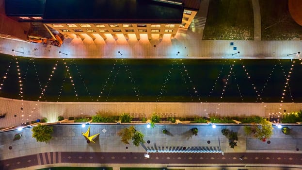 Aerial Night View of Illuminated Urban Space in Indianapolis with Star Sculpture and Water Feature