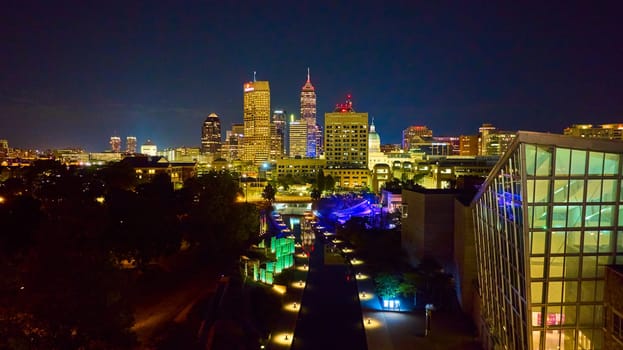Dazzling aerial view of Indianapolis business district, showcasing modern architecture and night illumination, captured with DJI Mavic 3 drone