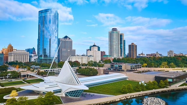 Daytime view of Milwaukee's diverse architecture, featuring the modern Quadracci Pavilion and towering skyscraper, captured by a DJI Mavic 3 drone.