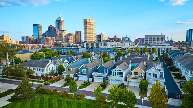 Sunset Over Indianapolis: Tranquil Suburban Homes and Bustling Downtown Skyline Captured from Elevated Perspective