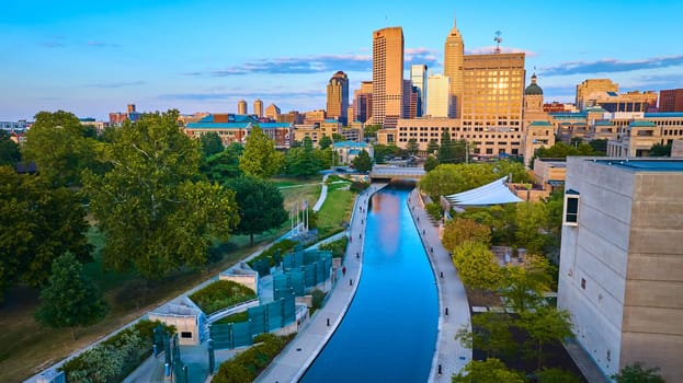 Sunset Glow on Indianapolis: Aerial View of Urban Development and Canal, Captured by Drone