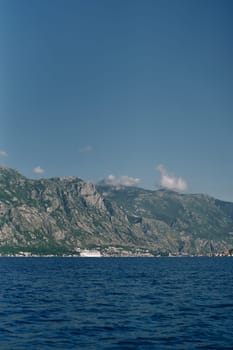 Cruise ship sails along the sea along the high mountain coast. High quality photo