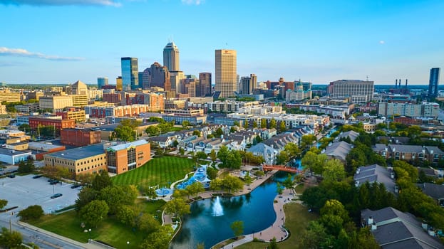 Sunset over Indianapolis - Aerial drone view of a tranquil urban park amidst a bustling city skyline, captured with a DJI Mavic 3 during 2023 golden hour.