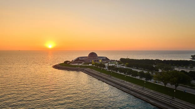 Image of Adler Planetarium with sunrise over Lake Michigan coast in summer aerial, Chicago, IL