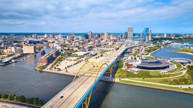 Sunny Aerial View of Downtown Milwaukee, Showcasing the Daniel W. Hoan Memorial Bridge, a Large Stadium, and Bustling Urban Landscape, Captured by DJI Mavic 3 Drone