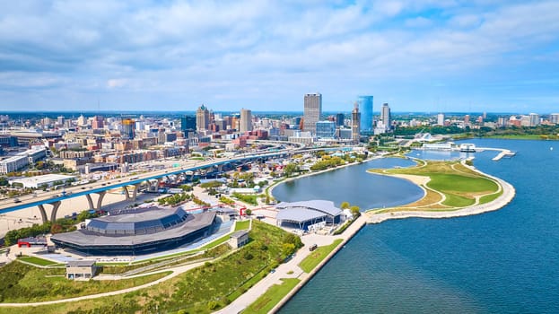 2023 Aerial view of vibrant Milwaukee cityscape, featuring iconic stadium and waterfront recreational area captured by DJI Mavic 3 drone over Lake Michigan