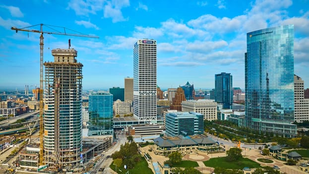 Sweeping Aerial View of Vibrant Milwaukee Cityscape Showcasing Ongoing High-Rise Construction, Modern Skyscrapers, and Urban Greenery, 2023