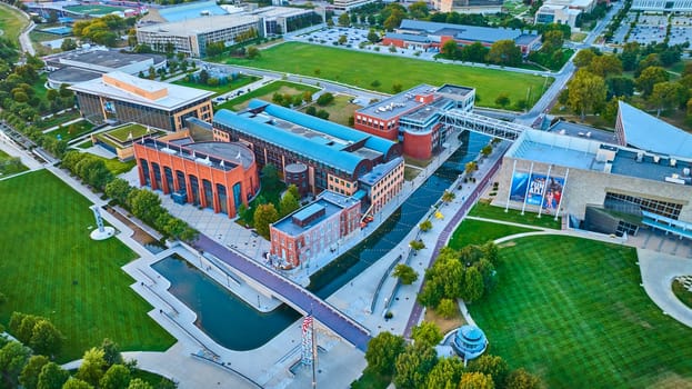 Aerial Dawn View of Modern Urban Campus in Indianapolis with Prominent Architecture, Manicured Landscapes, and Tranquil Water Features