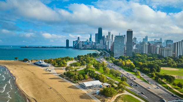 Image of Sandy beach coast aerial with Chicago downtown skyscrapers and Lake Michigan, tourism