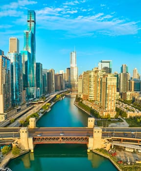 DJI Mavic 3 aerial panorama captures golden hour over Chicago's skyline, showcasing a contrast of modern and traditional architecture bridged by a bustling canal.