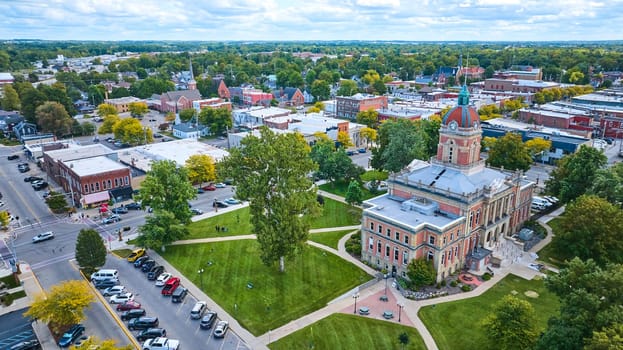 Aerial view of historic Elkhart County Courthouse with red dome in vibrant small town Goshen, Indiana, showcasing local community and urban planning