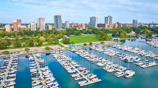 Aerial View of Vibrant Marina with Sailboats, Lush Park, and City Skyline in Milwaukee, Wisconsin