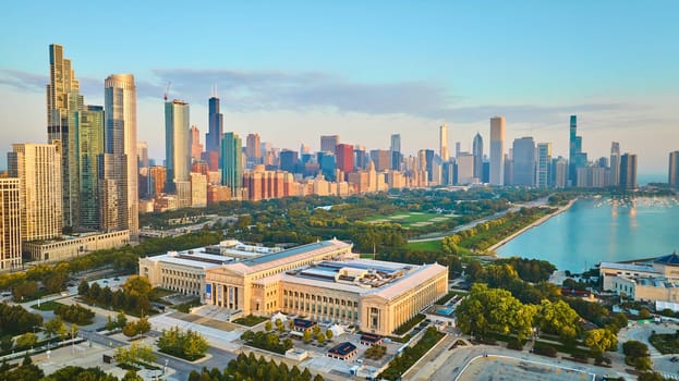 Image of Aerial Field Museum with city skyscrapers at sunrise and Lake Michigan in summer, Chicago IL