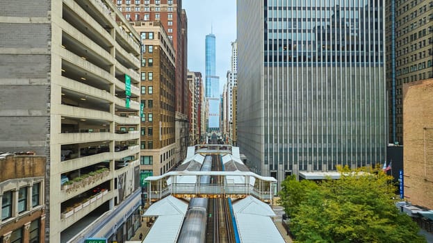 Image of Big city travel with Chicago train aerial of buildings leading to Trump Tower skyscraper