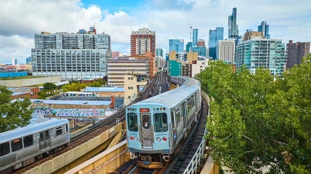 Image of Passenger trains tourism travel in big city with downtown skyscrapers in summer, Chicago aerial