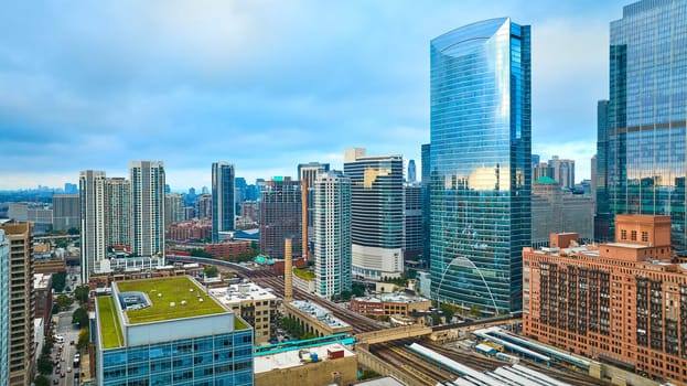 Image of Downtown skyscraper buildings in Chicago aerial with green, eco friendly rooftop in summer