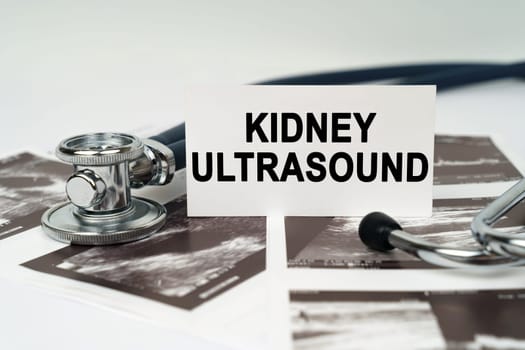 Medical concept. On the ultrasound pictures there is a stethoscope and a business card with the inscription - Kidney ultrasound