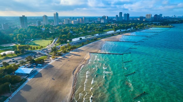 Image of Travel along beach and coast for Chicago tourism along Lake Michigan aerial of park and skyscrapers