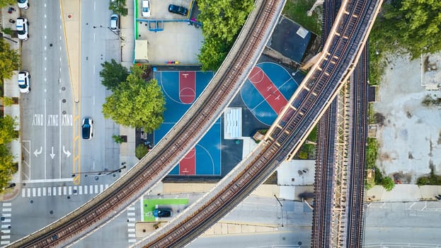 Image of Empty train track tourism transportation bridges above basketball courts aerial, Chicago IL