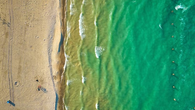 Image of Green water along sandy beach aerial of sunny waves and water, tourist, tourism and travel