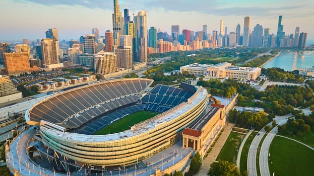 Image of Aerial Soldier Field Chicago football sports stadium with sunrise lighting, Illinois in summer
