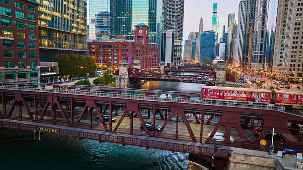 Image of Chicago bridges over canal aerial with city lights and skyscraper buildings in downtown, tourism