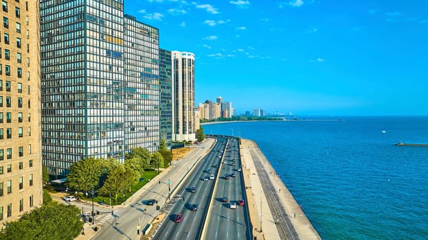 Image of Chicago coast skyscrapers with road tourism beside Lake Michigan on gorgeous summer day