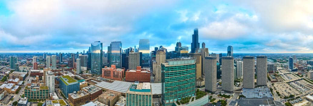 Aerial panorama of the 2023 Chicago skyline showing a bustling urban landscape with diverse skyscrapers under a gentle overcast light, captured using DJI Mavic 3 drone.