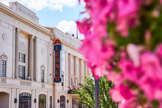 Elegant Lerner Theater facade in downtown Elkhart, Indiana, highlighting vibrant pink flowers and historic architecture