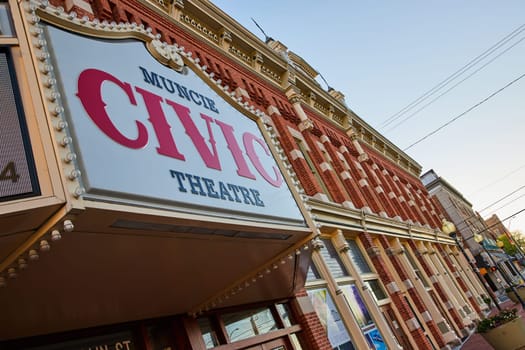 Early evening view of the historic Muncie Civic Theatre, with its nostalgic marquee sign and ornate architecture, in downtown Indiana, 2023.