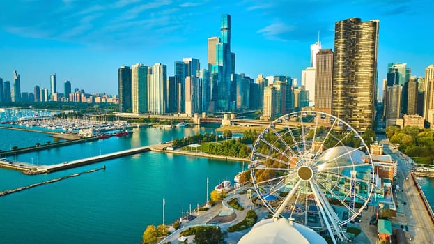 Image of Tourism coast aerial Navy Pier Centennial Wheel sunrise with skyscrapers in Chicago, Lake Michigan