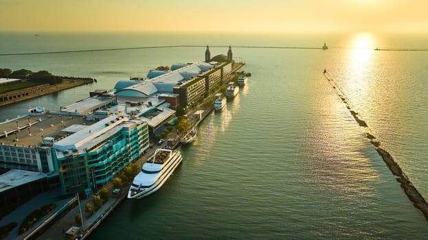 Image of Boat docked Navy Pier on Lake Michigan sunrise aerial in summer dawn, Chicago, IL