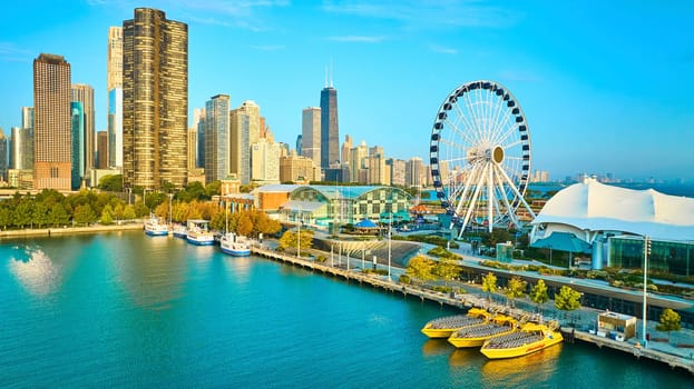 Image of Aerial Centennial Wheel on Navy Pier with Chicago, IL skyscrapers in summer at dawn