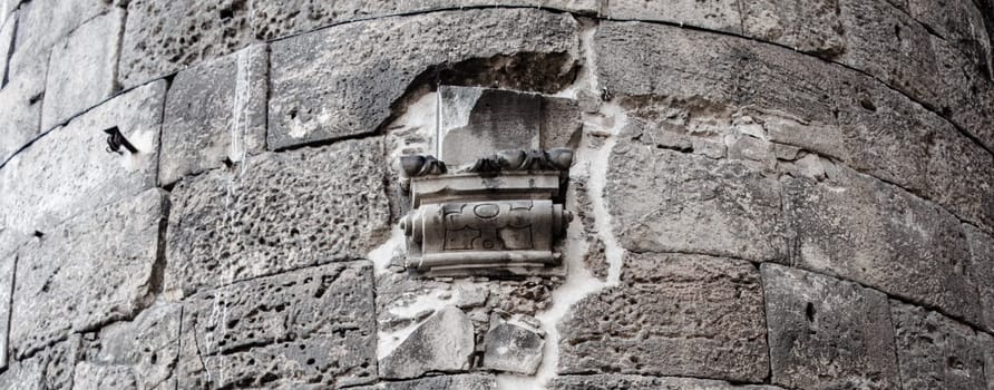 Close up old gray brick textured wall concept photo. Mediterranean architecture, urban city life. District of European town, Barcelona. High quality picture for wallpaper, travel blog.