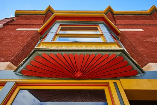 Vibrant Detail of Victorian Architecture in Downtown Muncie, Indiana - Colorful Ornamental Features Under Sunny Sky