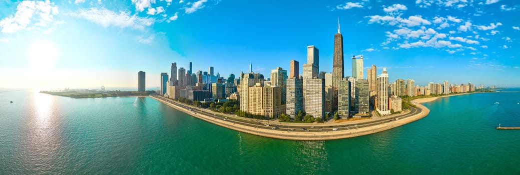 Sweeping panorama of Chicago's vibrant skyline, captured from a high vantage point during the golden hour through a DJI Mavic 3 drone, showcasing the architectural marvel of the John Hancock Center beside tranquil Lake Michigan.