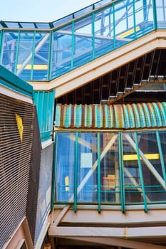 Abstract view of a weathered metal stairway under a modern glass enclosure in Chicago, illustrating urban decay and renewal.