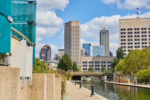 Vibrant Indianapolis cityscape in 2023 featuring a bustling business district, lush green spaces, and tranquil waterfront promenade.