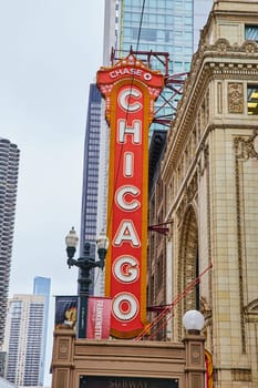 Image of Large orange Chicago sign with white lettering on old historic building in city