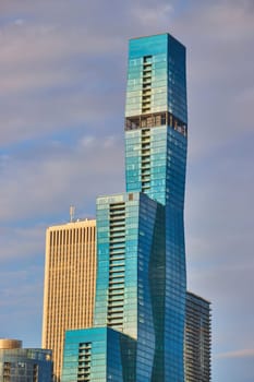 Image of Blue skyscraper with multiple tiers in Chicago with golden light in summer and purple tinged sky
