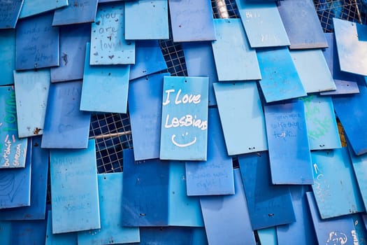 Blue Tiles of Expression: A vibrant, community-created art display showcasing individual messages, LGBTQ pride, and diversity at an Art Center in Indianapolis, Indiana, 2023.
