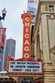 Image of Large orange Chicago sign with white lettering above a theatre sign