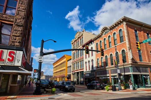 Vibrant city life on a sunny day in Downtown Muncie, Indiana, 2023 - Historic architecture, bustling traffic, and pedestrian lifestyle captured in a vivid urban scene.