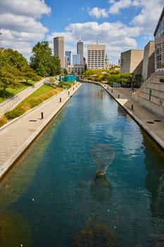 Vibrant canal view in Indianapolis, showcasing modern architecture, public art and urban renewal in 2023