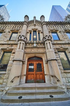 Image of Entrance Chicago Water Works castle like building architecture with steps and city skyscrapers